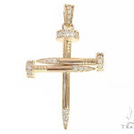 14k yellow gold cross pendant shaped like nails with diamond accents.