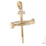 14k yellow gold cross pendant shaped like nails with diamond accents.