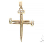 14k yellow gold cross pendant shaped like nails with diamond accents.