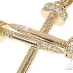 14k yellow gold cross pendant shaped like nails with diamond accents.