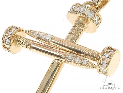 14k yellow gold cross pendant shaped like nails with diamond accents.