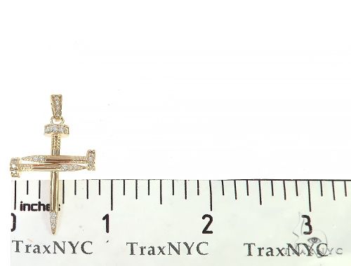 14k yellow gold cross pendant shaped like nails with diamond accents.