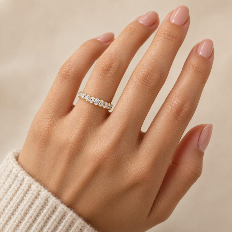 14K gold petite oval lab-grown diamond wedding band worn on the hand