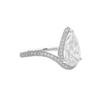 Pear-shaped diamond engagement ring with pavé diamond band in white gold.