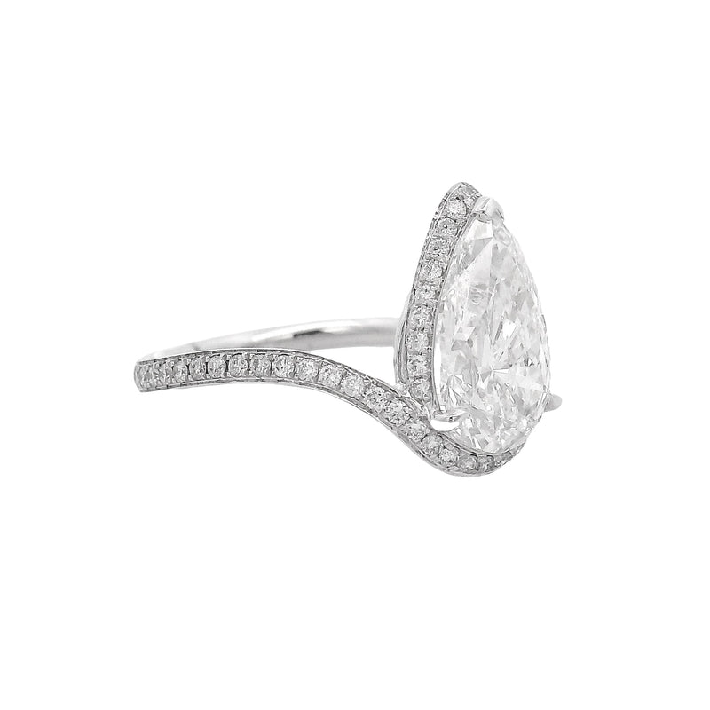 Pear-shaped diamond engagement ring with pavé diamond band in white gold.