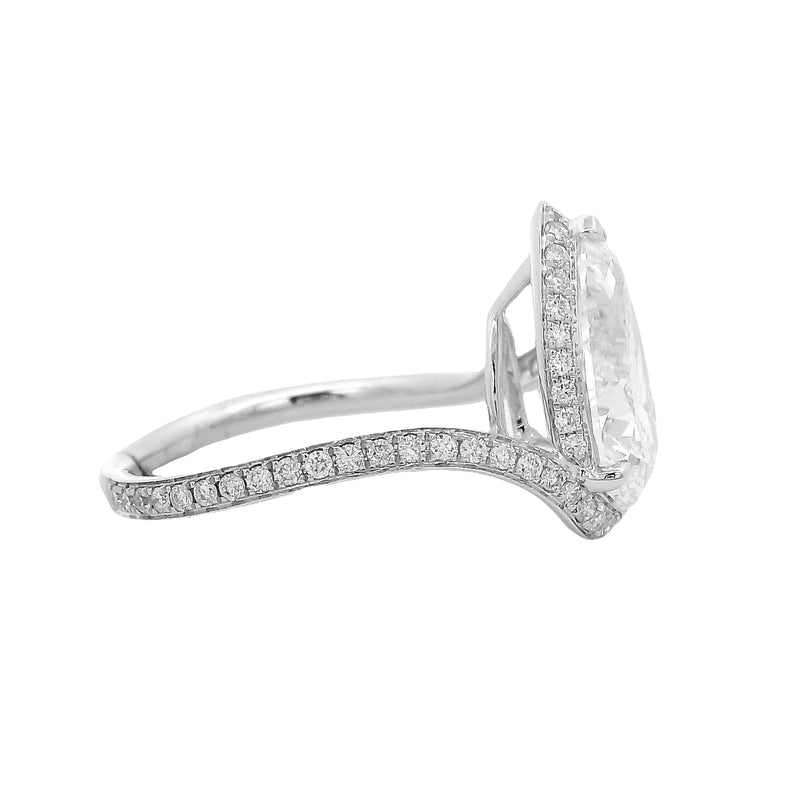 Pear-shaped diamond engagement ring with pavé diamond band in white gold.