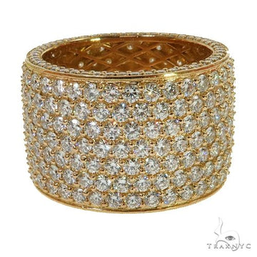 Wide 18K yellow gold eternity ring encrusted with multiple rows of round diamonds.