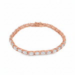 White gold tennis bracelet with oval-cut diamonds in a linked setting.
