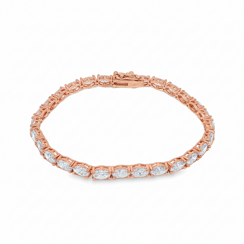 White gold tennis bracelet with oval-cut diamonds in a linked setting.
