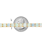 Gold tennis bracelet with round opal gemstones evenly set along the band.
