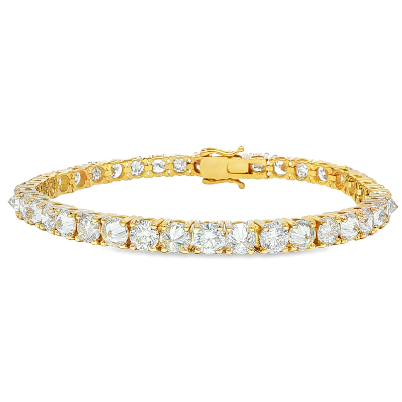 Yellow gold tennis bracelet with alternating upside-down round diamonds in secure clasp.