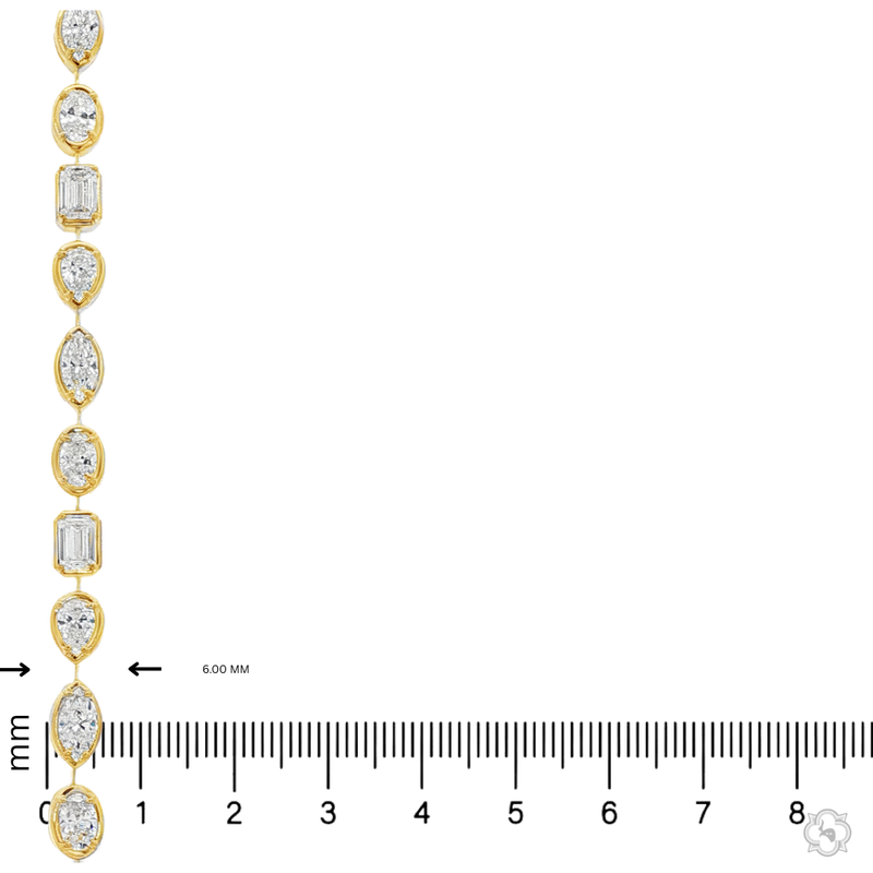 Yellow gold tennis bracelet featuring multi-shape sparkling diamonds in assorted cuts.