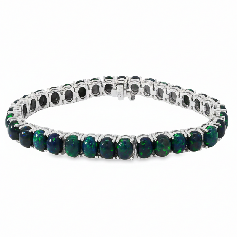White gold tennis bracelet with oval black opal gemstones in prong settings.