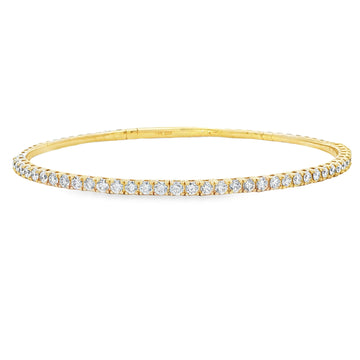 Yellow gold flexible bangle bracelet with a single row of round diamonds.