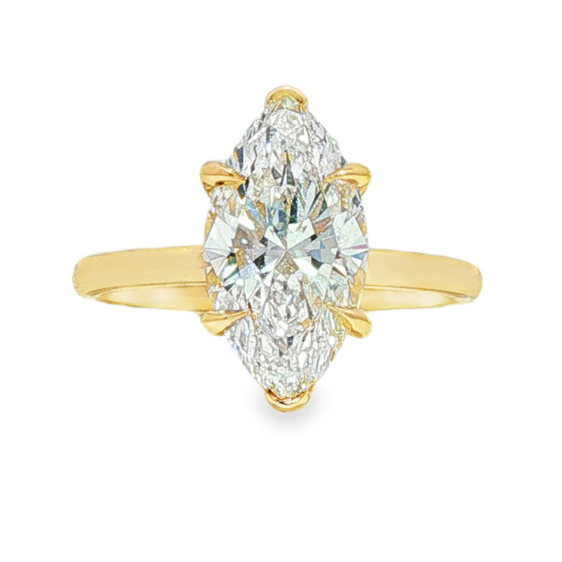 Yellow gold marquise solitaire engagement ring with elongated diamond center stone.