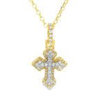 White gold mini cross pendant with sparkling diamond accents on chain.