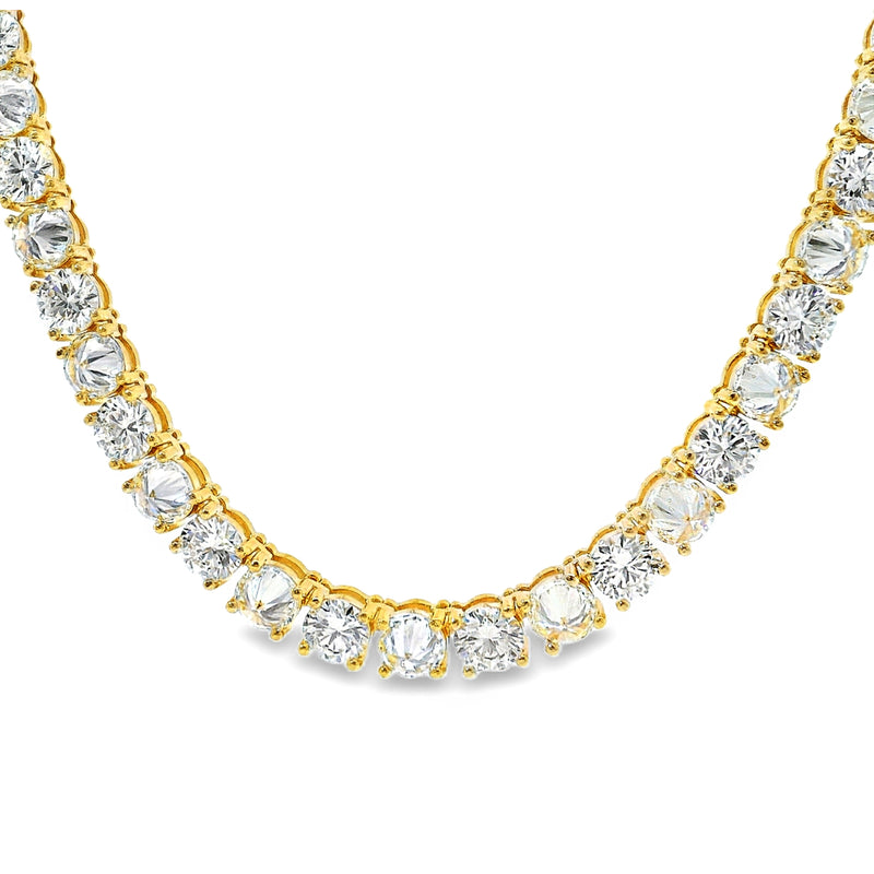 Yellow gold tennis chain with alternating upside down round diamonds.
