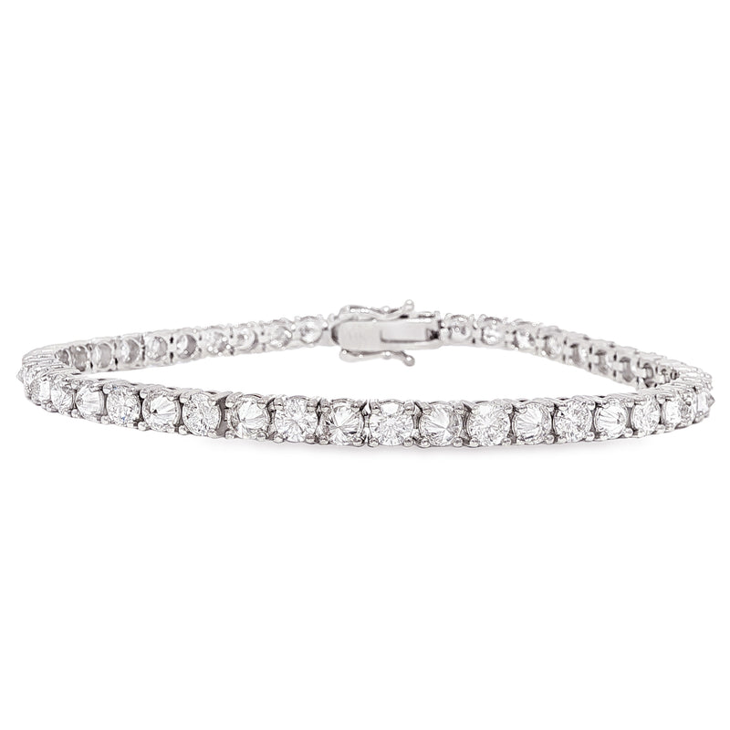 White gold tennis bracelet with alternating upside down round diamonds in a sleek setting.
