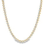 Yellow gold tennis chain necklace with round sparkling diamonds in a classic setting.