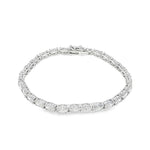 White gold tennis bracelet with oval-cut diamonds in a linked setting.