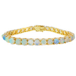 Yellow gold tennis bracelet with round opal gemstones in a sleek, elegant setting.