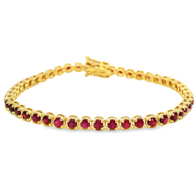 Yellow gold tennis bracelet with round ruby gemstones and secure clasp closure.