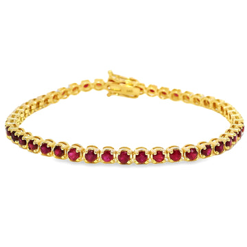 Yellow gold tennis bracelet with round ruby gemstones and secure clasp closure.