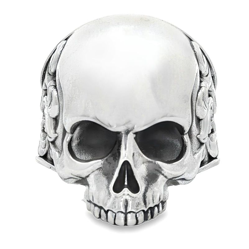 Silver skull ring with antique finish and ornate floral engravings on the band.
