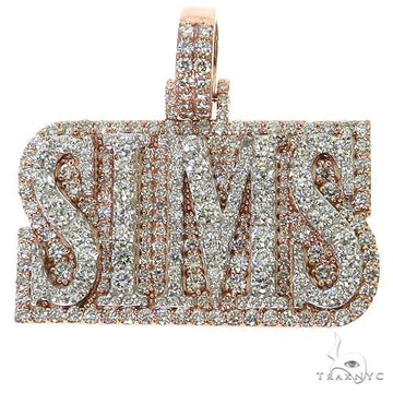 Two-tone gold SIMS diamond pendant with pavé-set round diamonds.