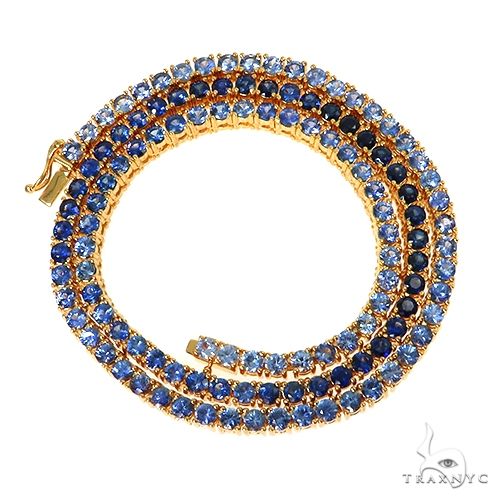 Graduated blue sapphire tennis chain in 14k gold – tapered center-heavy stone layout, full length view