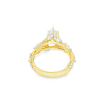 Marquise diamond engagement ring in yellow gold with intricate side diamond accents.