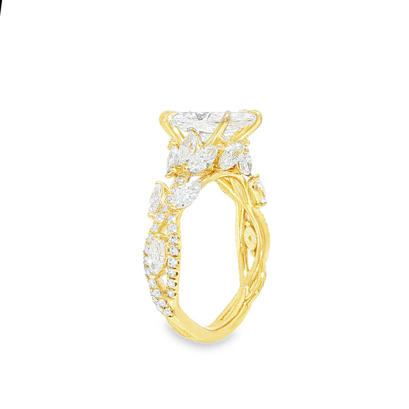 Marquise diamond engagement ring in yellow gold with intricate side diamond accents.
