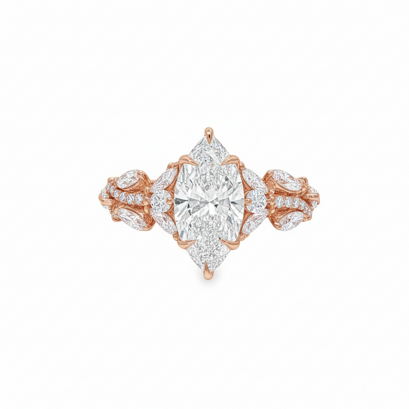 Marquise diamond engagement ring in yellow gold with intricate side diamond accents.