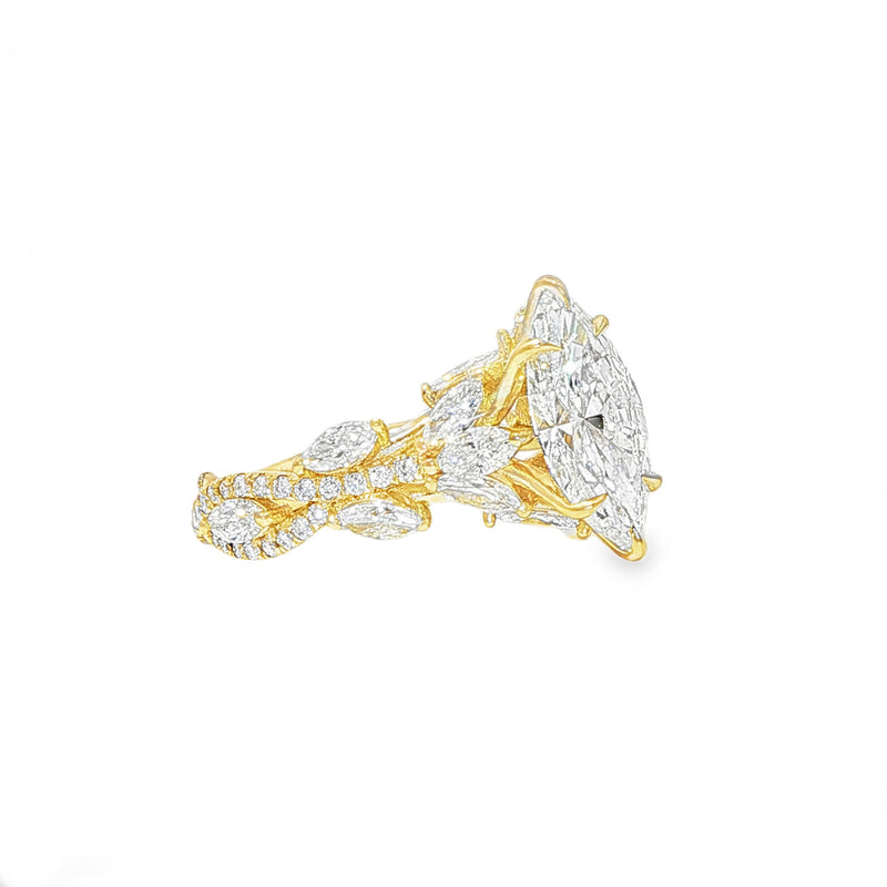 Marquise diamond engagement ring in yellow gold with intricate side diamond accents.