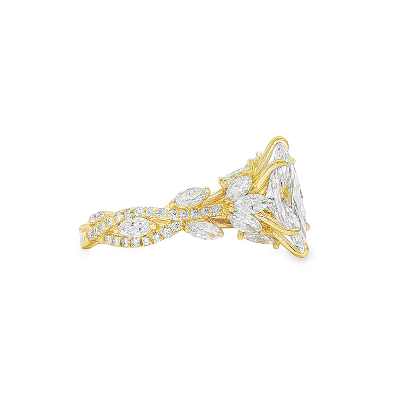 Marquise diamond engagement ring in yellow gold with intricate side diamond accents.