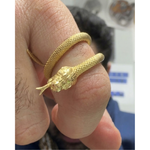 24K gold snake ring with textured body and detailed snakehead design wrapping around finger.