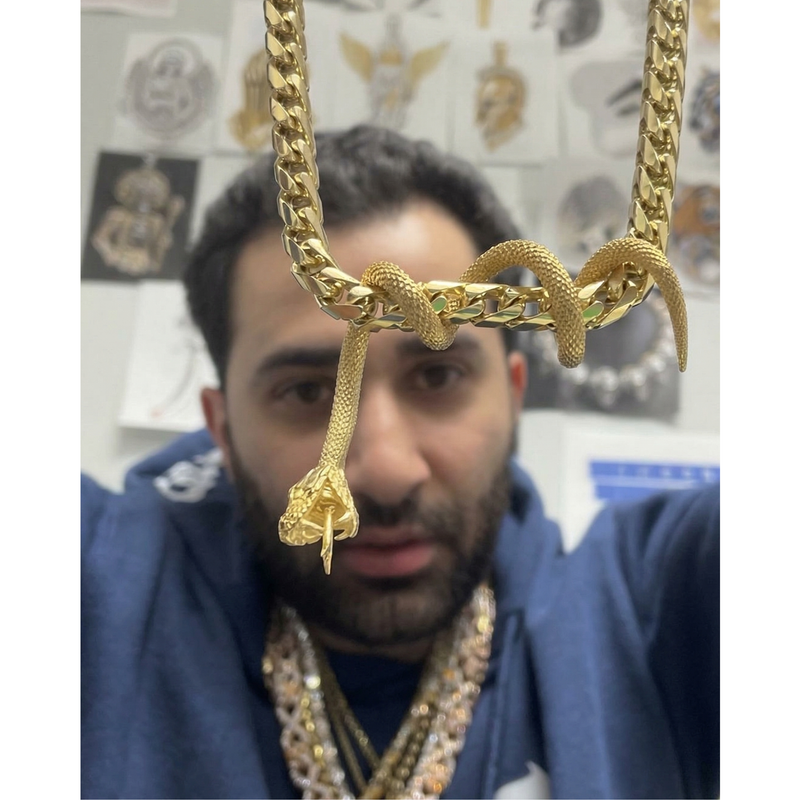 24K gold snake pendant with detailed scales on a thick gold chain necklace.