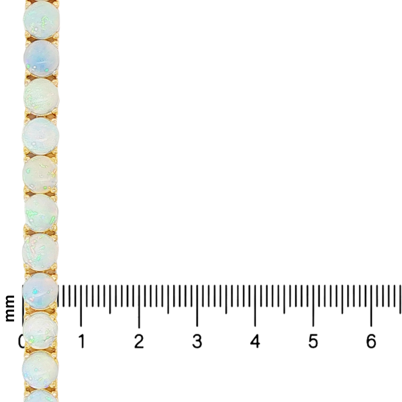 Gold chain with round opal gemstones set evenly along its length, next to a millimeter ruler for scale.