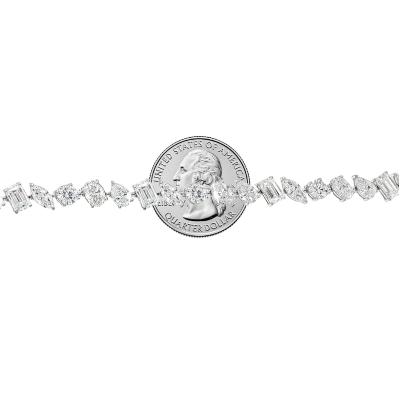 White gold diamond tennis chain with multi-shaped stones in a continuous link design.