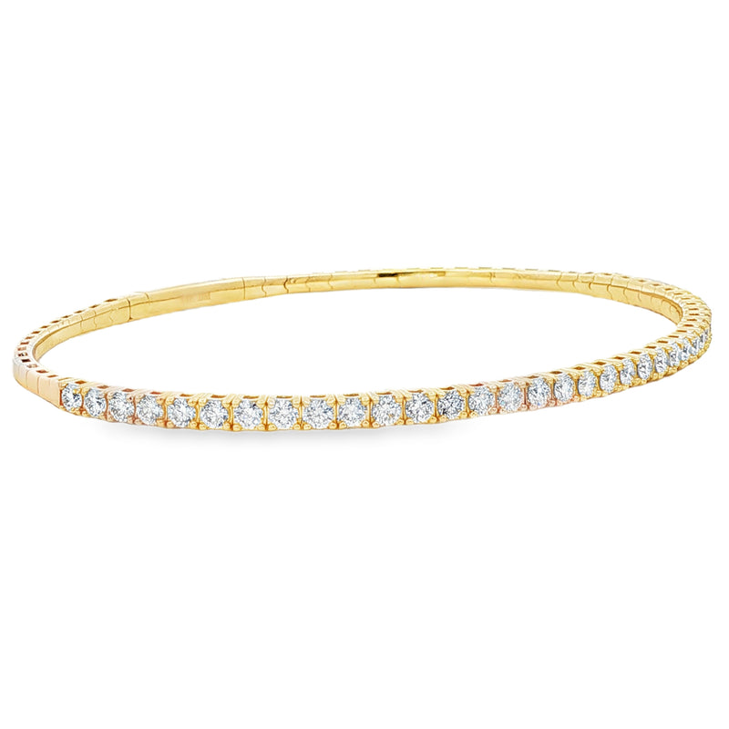 Yellow gold flexible bangle bracelet with a single row of round diamonds
