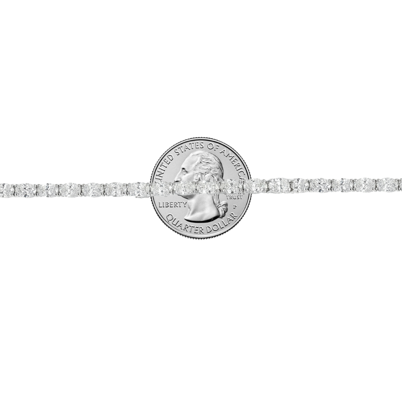 White gold tennis bracelet with oval-cut diamonds in a linked setting.