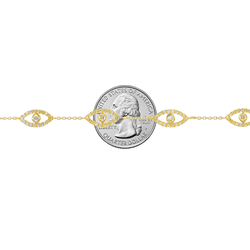 Gold bracelet with evil eye motifs adorned with yellow diamonds and clear stones.