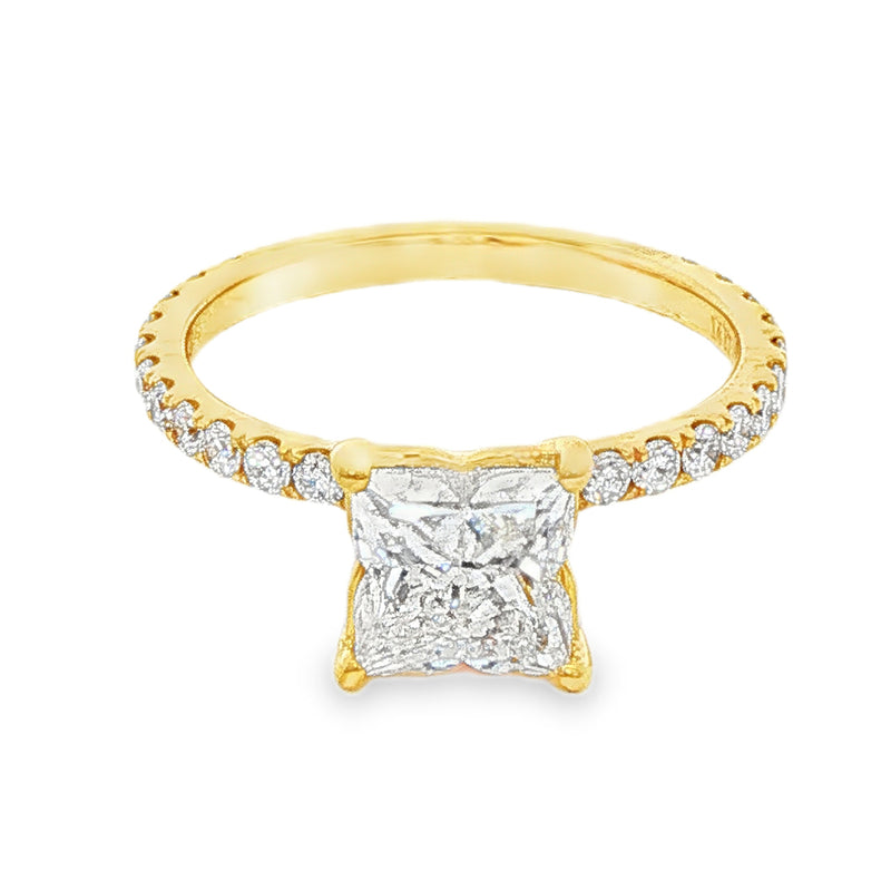 Yellow gold engagement ring with flower-cut square diamond and side diamonds on band.