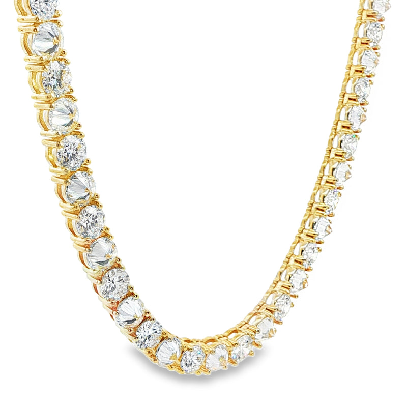 Yellow gold tennis chain with alternating upside down round diamonds.
