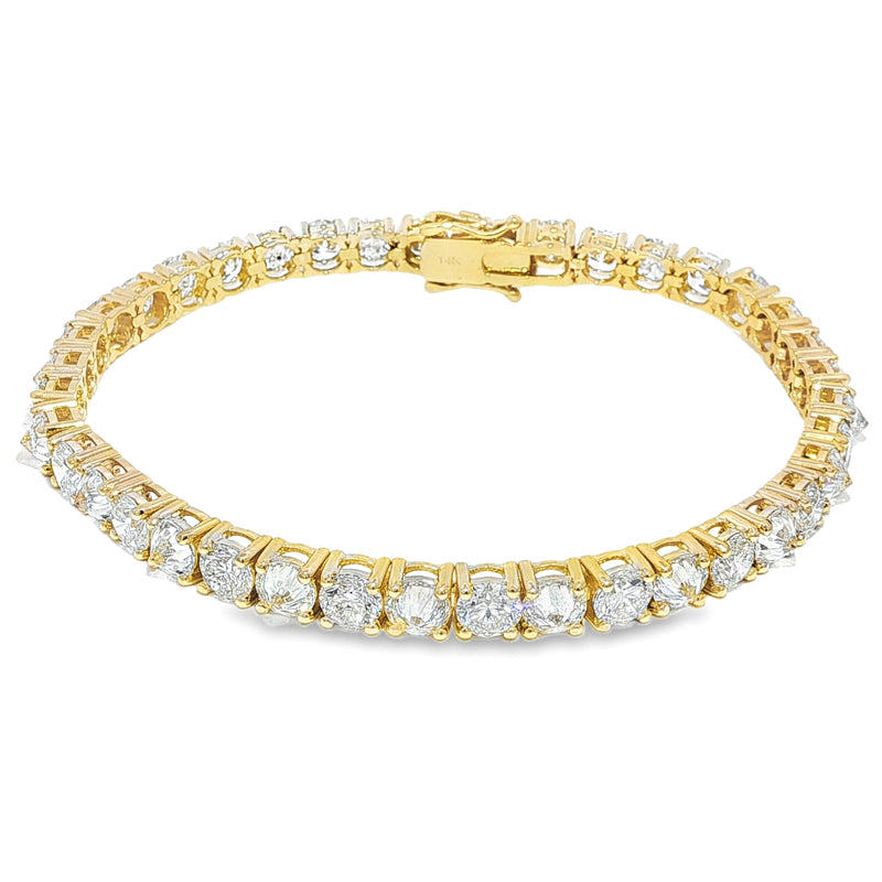 Yellow gold tennis bracelet with alternating upside-down round diamonds in secure clasp.