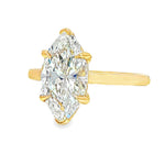 Yellow gold marquise solitaire engagement ring with a large central diamond.