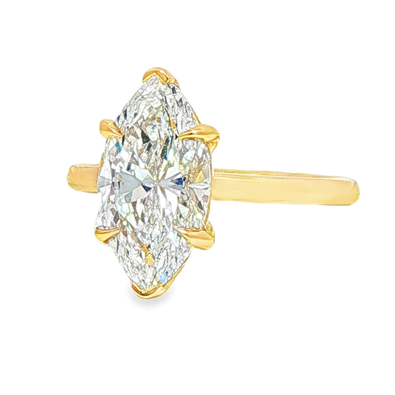 Yellow gold marquise solitaire engagement ring with a large central diamond.
