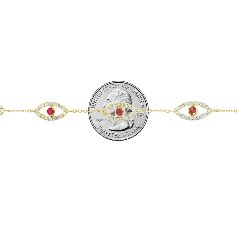 Gold bracelet with five evil eye charms featuring white diamonds and central rubies.