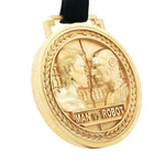 Gold Man vs Robot medal pendant with black cord and intricate laurel border design.
