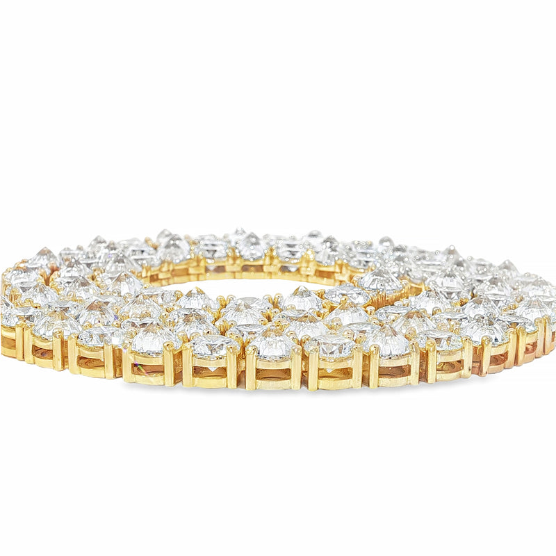 Yellow gold tennis chain with alternating upside down round diamonds.
